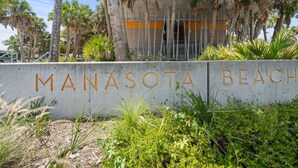 A concrete wall with "MANASOTA BEACH" written in large letters. - Venice Home near Venice Downtown & Venice Beach (Venice)
