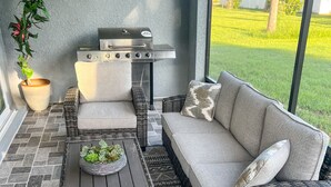 A patio with a grill, wicker furniture, and a potted plant. - Venice Home near Venice Downtown & Venice Beach (Venice)