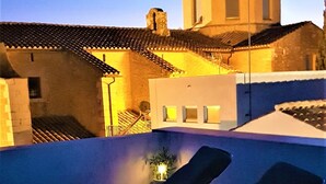 A rooftop with two sun loungers and a small potted plant. - Rural tourist apartment with spa area. Main Square. PB. Sant Jordi (Sant Jordi)