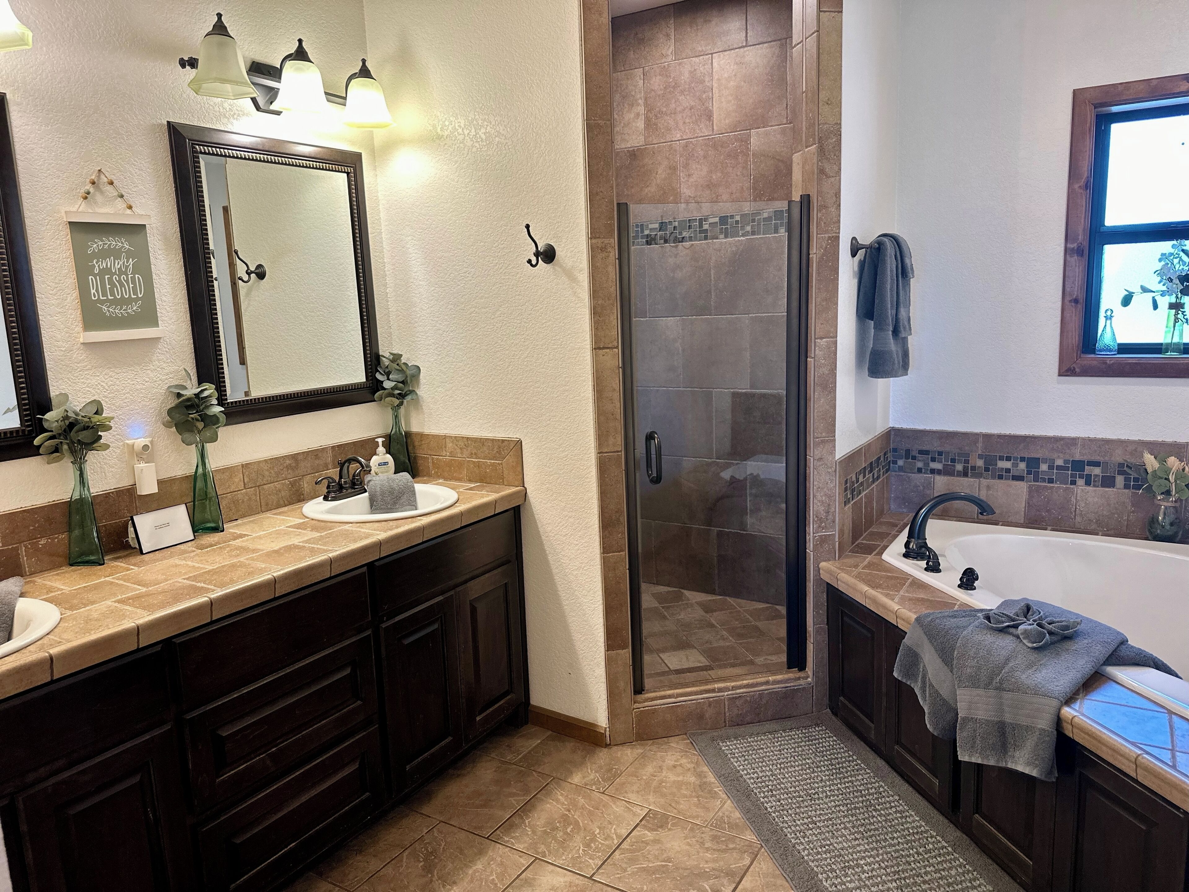 A bathroom with two sinks, a shower, and a bathtub.