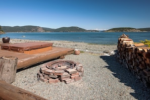 Relax by the lake with a fire pit and scenic views.