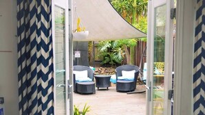 An outdoor patio area with wicker furniture and a canopy. - Aptos Beach Retreat Hot Tub & 5 Min Walk to Sand (Aptos)