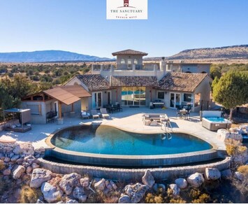 Desert oasis: The Sanctuary's infinity pool meets endless views. Calibrate in modern comfort surrounded by Arizona's rugged beauty. Your exclusive, private, luxe retreat awaits.