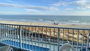 A balcony with a view of a beach and a swimming pool. - Luxury Ocean Front (Murrells Inlet)