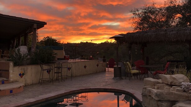A pool with a clear view of the sky, surrounded by outdoor seating and a stone wall. - 3Bd/2b home, near wedding locations, wineries, Temecula, Resort & Casinos, Views (Fallbrook)