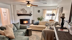 A cozy living room with a fireplace, two sofas, a coffee table, and a dining table. - 3Bd/2b home, near wedding locations, wineries, Temecula, Resort & Casinos, Views (Fallbrook)