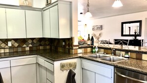 A kitchen with white cabinets, a granite countertop, a stainless steel sink, and a hanging light fixture. - 3Bd/2b home, near wedding locations, wineries, Temecula, Resort & Casinos, Views (Fallbrook)