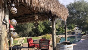 A patio area with a pool, red chairs, a wooden barrel, and hanging decorative lights. - 3Bd/2b home, near wedding locations, wineries, Temecula, Resort & Casinos, Views (Fallbrook)