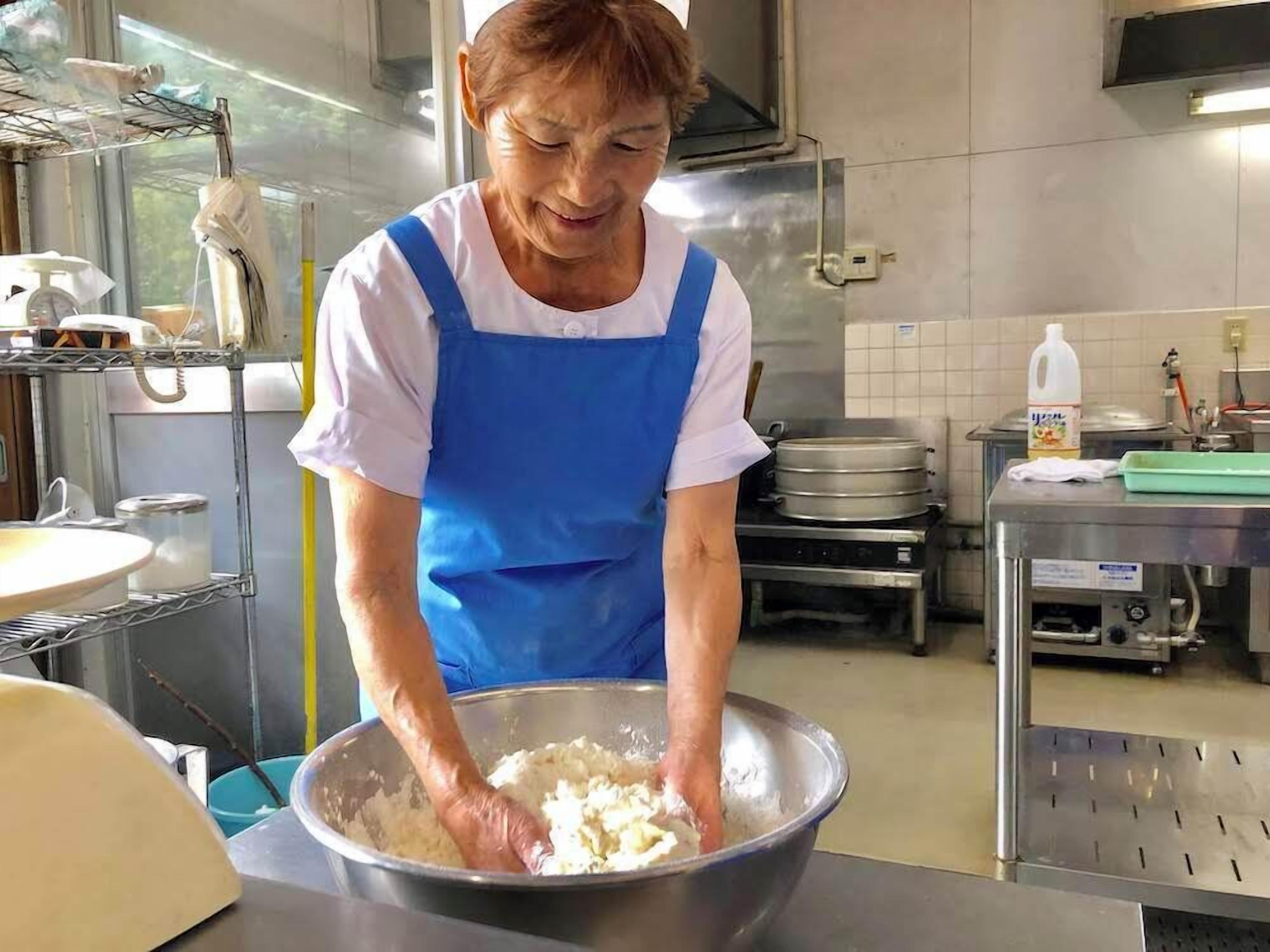 A person in a kitchen preparing food.