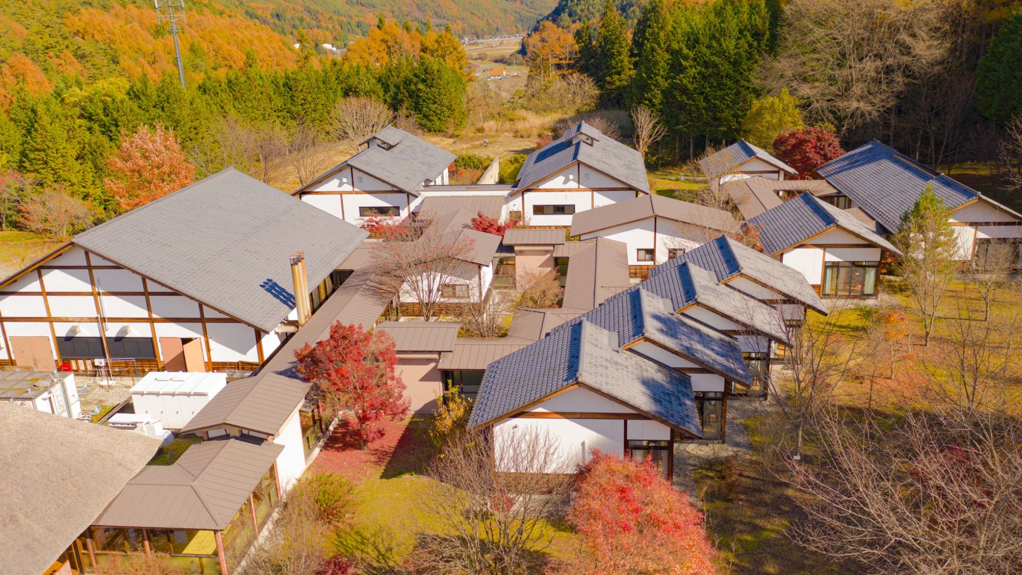 A residential area with multiple houses featuring sloped roofs and solar panels.