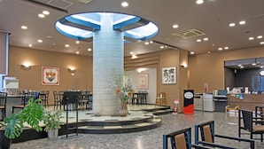 A hotel lobby with a central pillar, seating areas, a reception desk, and decorative elements. - Hotel Fukuya (Takamatsu)