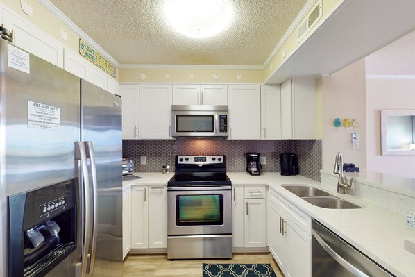 Enjoy cooking in this well-equipped kitchen with stainless steel appliances, a water dispenser, double sink, and dishwasher.