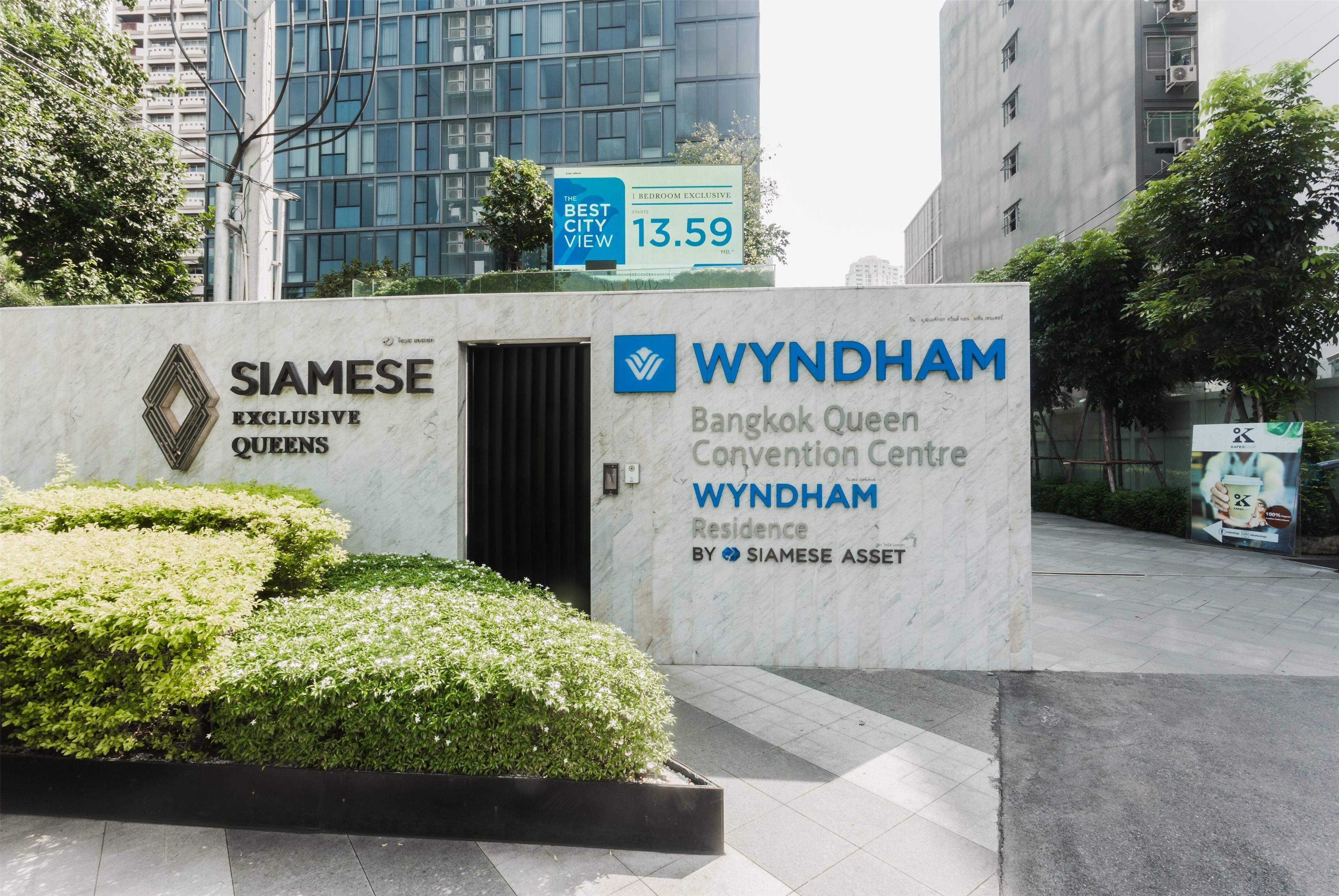 A sign for Wyndham Bangkok Queen Convention Centre Wyndham Residence by Siamese Asset, with a price tag of 13.59.