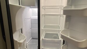An open refrigerator with multiple shelves and compartments, including a freezer section at the top. - 3 Bedroom House in Fort Recovery (Fort Recovery)