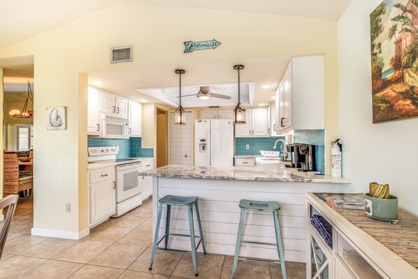 Enjoy cooking in this well-equipped kitchen with a central island and barstools.