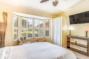 Relax in comfort with a large bed, flat-screen TV, and a console table.