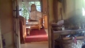 A room with a bed, a wooden table, and a chair.
