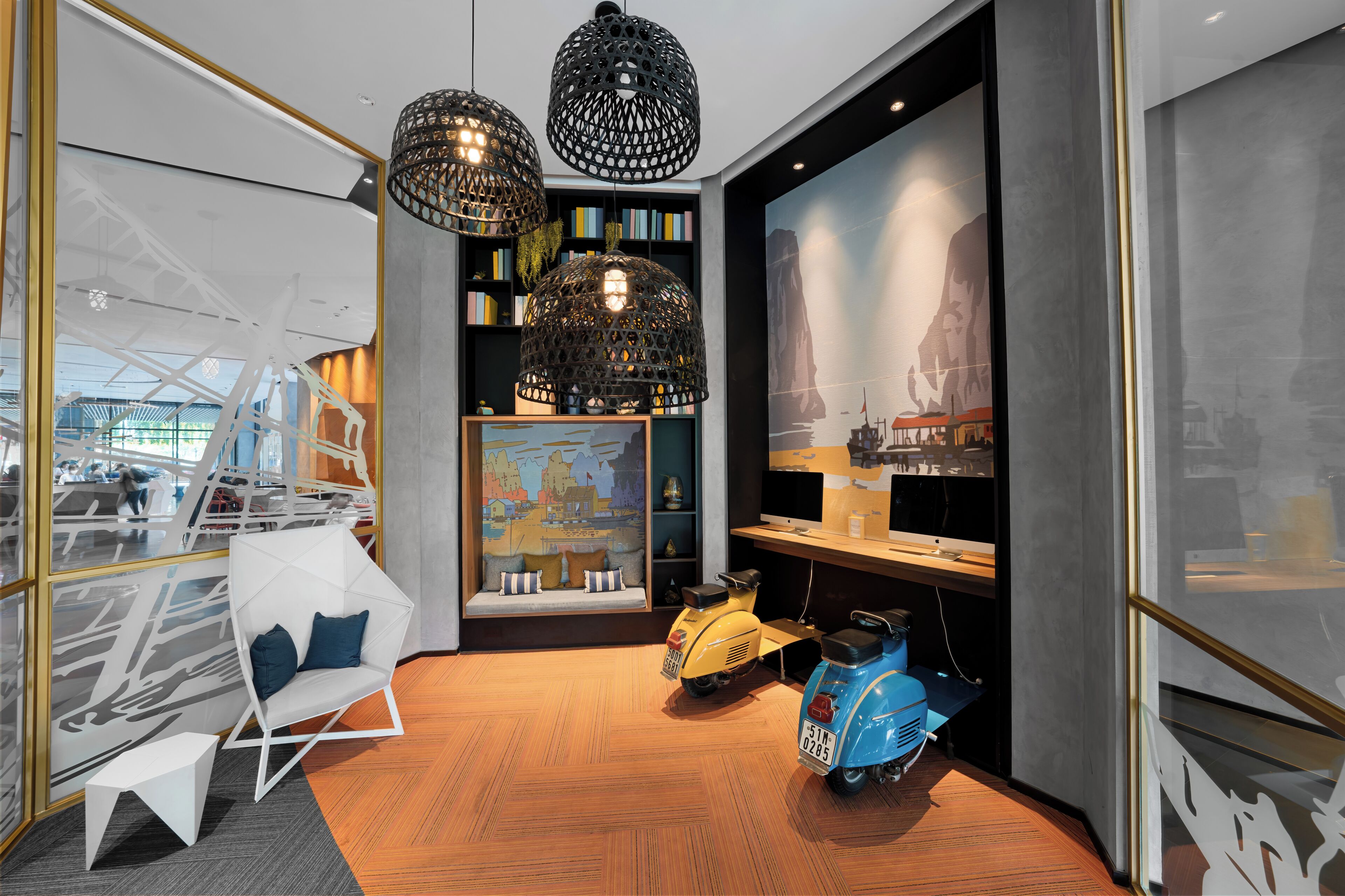 A modern interior with a seating area, decorative lighting, and a view of the outside.