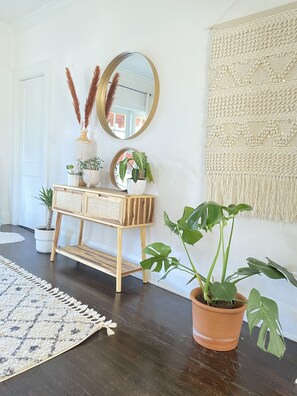 Enter a welcoming space with a console table, mirror, and potted plants.
