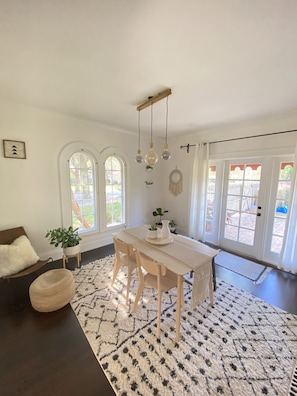 Relax in this stylish space with a large dining table, comfortable seating area, and a spacious feel.