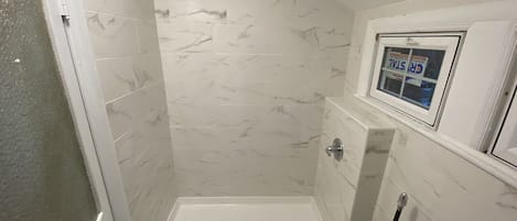 Combined shower/tub, towels, soap, shampoo