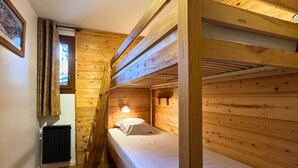 A wooden bunk bed room with a window, a radiator, and a ladder. - Apartment at the foot of the slopes - 4 guests (Les Belleville)