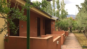 A row of single-room cabins with a brick pathway leading to a grassy area. - Gaia B&b (Castrovillari)
