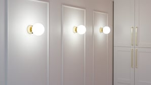 Three doors with circular light fixtures and a white wardrobe with gold handles. - Climatic Studio with Terrace | 500 m to the Old Town Square (Poznan)