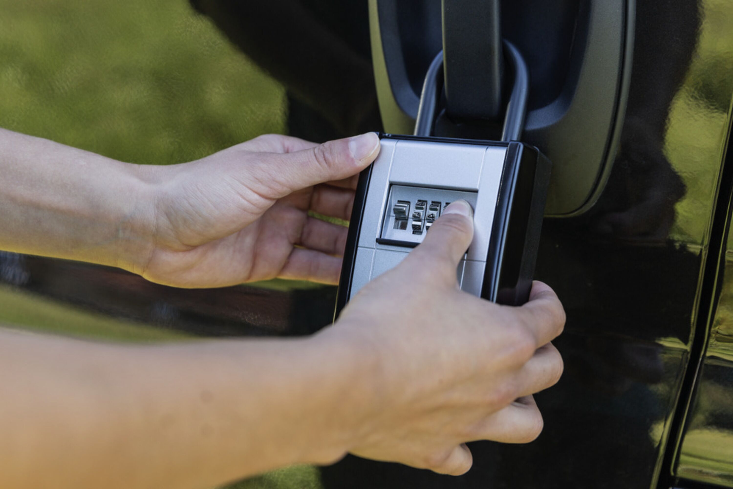 A person using a car key fob.