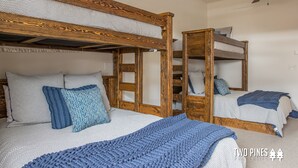 A room with bunk beds, a ceiling fan, and a window. - Inviting Spanish Peaks Townhome|Private Hot Tub| 15 min Drive to Resort (Big Sky)