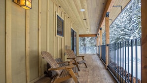 A wooden porch with benches and a railing overlooking a snowy landscape. - Gorgeous Home! Private Deck, Hot Tub, Stunning Views, 15 Min Drive to  Resort! (Big Sky)