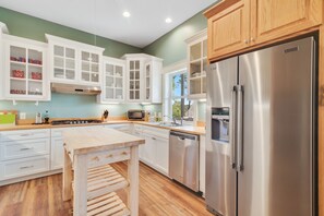 Enjoy cooking in this well-equipped kitchen with a stainless steel refrigerator, dishwasher, and microwave.