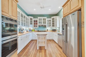Enjoy cooking in this well-equipped kitchen with a central island, oven, microwave, and dishwasher.