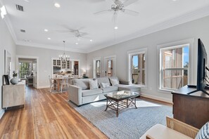 Relax in this open living area with a large sofa, dining table for four, and glass coffee table.