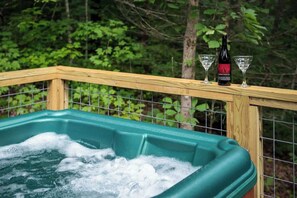 A hot tub with a wooden deck and a bottle of wine. - Free Dollywood tix and relaxing hot tub in woods (Sevierville)