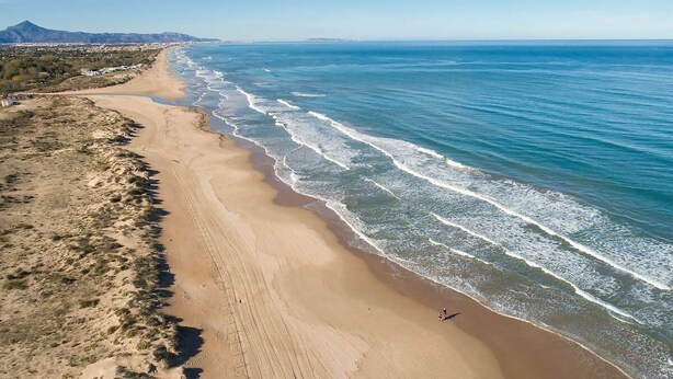 A coastal beach with a clear view of the ocean and a distant mountain range. - Solea Mare by Midelisa (oliva nova golf)