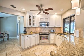 Fridge, microwave, stovetop, dishwasher - Screened-In Private Pool: Waterfront Home (Cape Coral)
