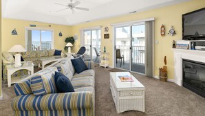 A living room with a sofa, coffee table, and a television. - 3 Br with pool midtown steps to beach, restaurants and amusements (Ocean City)