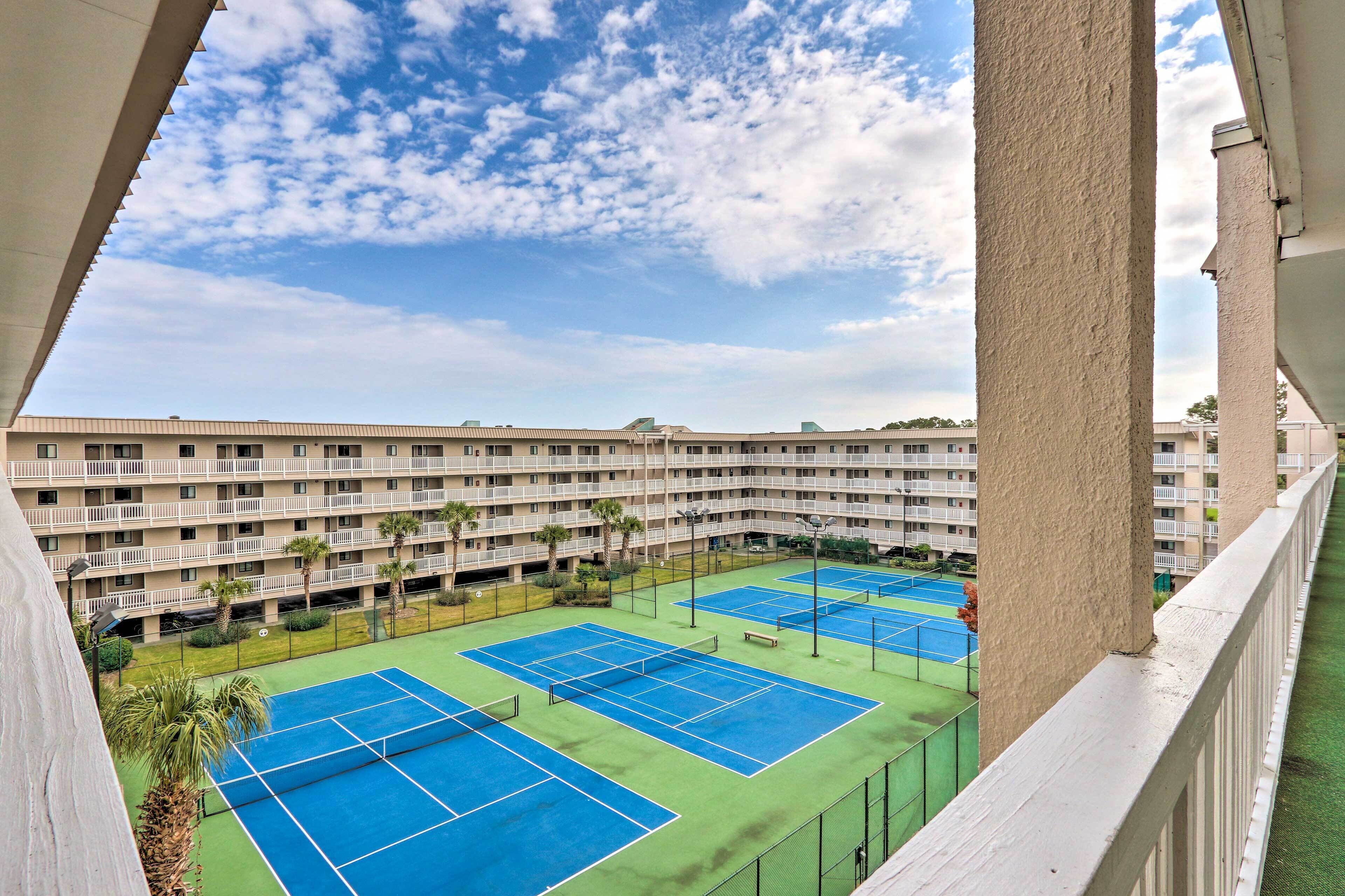 A multi-story hotel with a tennis court complex.
