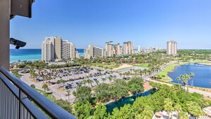 A high-rise hotel with a view of a marina and ocean. - Balcony & Views! 'Beach Bliss' in Sandestin Resort (Destin)