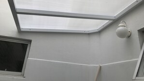 A skylight with a white frame and a wall-mounted light fixture. - Near Praia do Forte - second block (Cabo Frio)