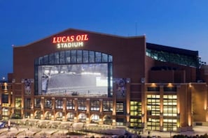 A stadium with a large illuminated sign reading 'Lucas Oil Stadium.' - Luxe Loft Downtown (Indianapolis)
