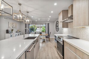 Enjoy cooking in this well-lit kitchen with a central island, sink, and large oven.