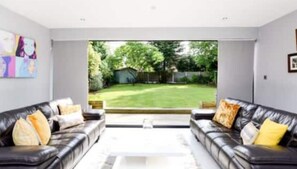 Relax in a peaceful space with a view of the well-maintained lawn and outdoor area.