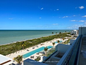 Un resort con piscina, spiaggia e vista sull'oceano.