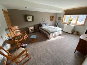 A bedroom with a bed, wooden furniture, a desk, and a window. - Quiet, comfortable bed & breakfast in a gorgeous rural setting! (Spring Valley)