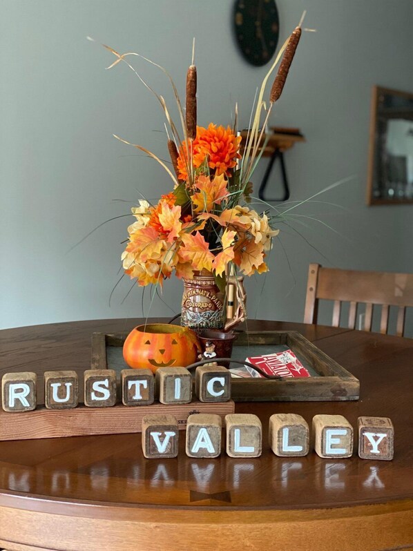A rustic table setting with a vase of autumn leaves and a carved pumpkin. - Quiet, comfortable bed & breakfast in a gorgeous rural setting! (Spring Valley)