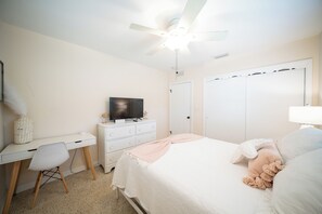 A bedroom with a bed, a desk, a chair, a television, and a wardrobe. - N HYDE PARK, UT, RIVERWALK, RAYMOND JAMES STADIUM,ALESSI, SOHO, MIDTOWN 5 STARS! (Tampa)