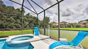 A swimming pool with a hot tub, lounge chairs, and a view of the surrounding area. - Private Pool! Game room! Minutes to Disney! Themed rooms! (Kissimmee)