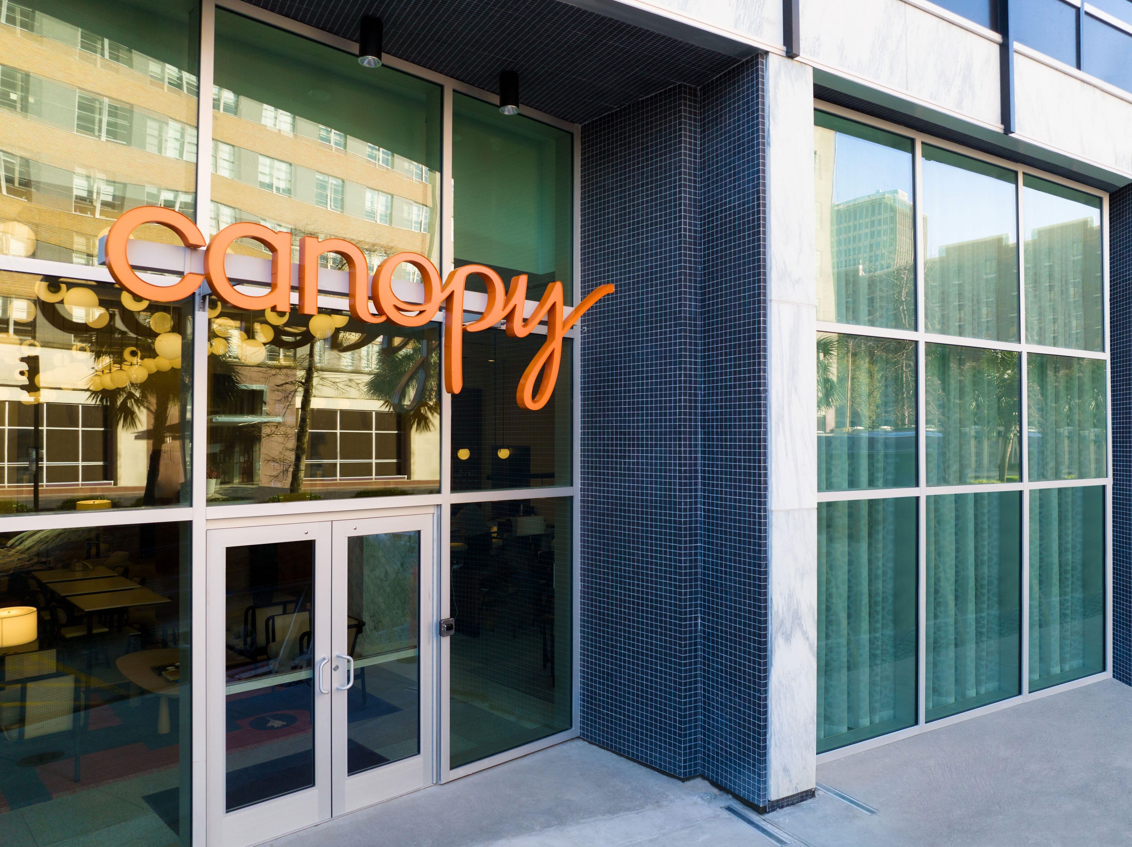 A building with a large glass facade and a prominent 'canopy' sign.